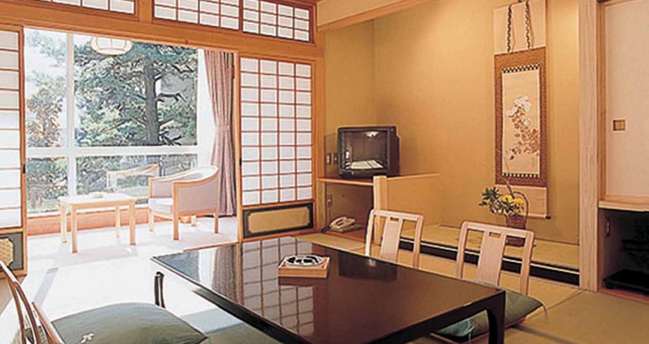 Staying in a Japanese Ryokan (traditional hotel) adds to the cultural experience. - image 0
